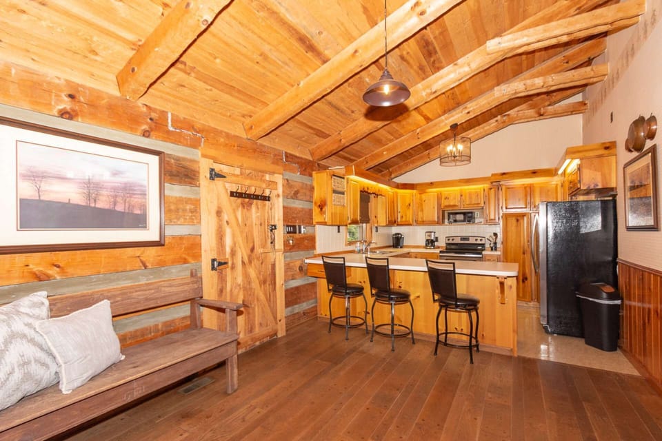 Well-appointed kitchen with 3-chairs at the counter, door access to screened in porch area.