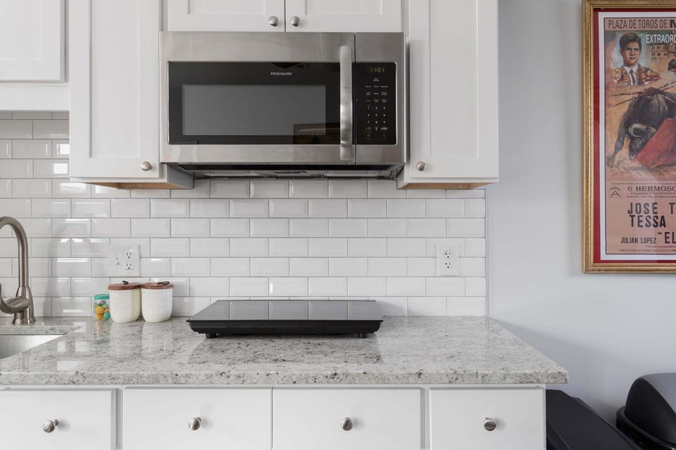 Microwave and cooktop available, as are pots and pans.