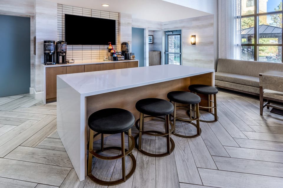 Coffee station in the lobby — fuel up before hitting the Cherry Creek Trail out back