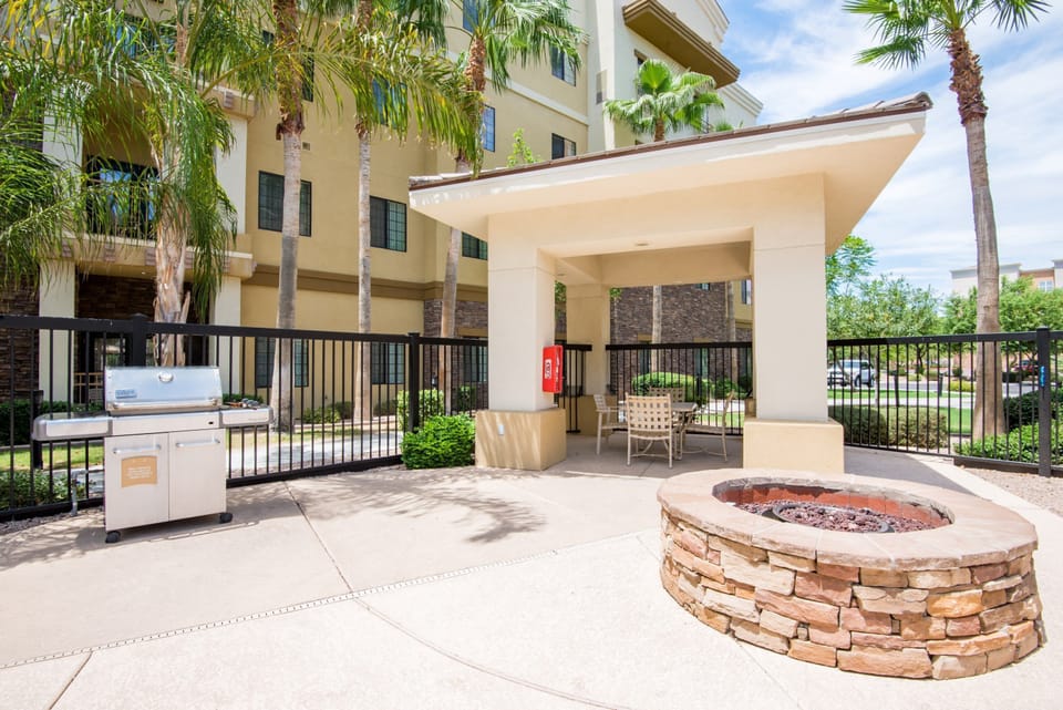 Outdoor grilling area with a fire pit and seating.