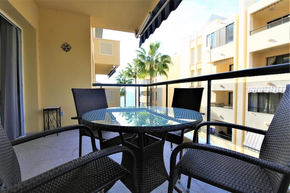 Lovely balcony with outside dining area for four and partial sea views