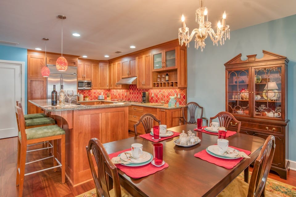 The gourmet kitchen has beautiful cabinetry, stainless fixtures and colorful surround and accents.