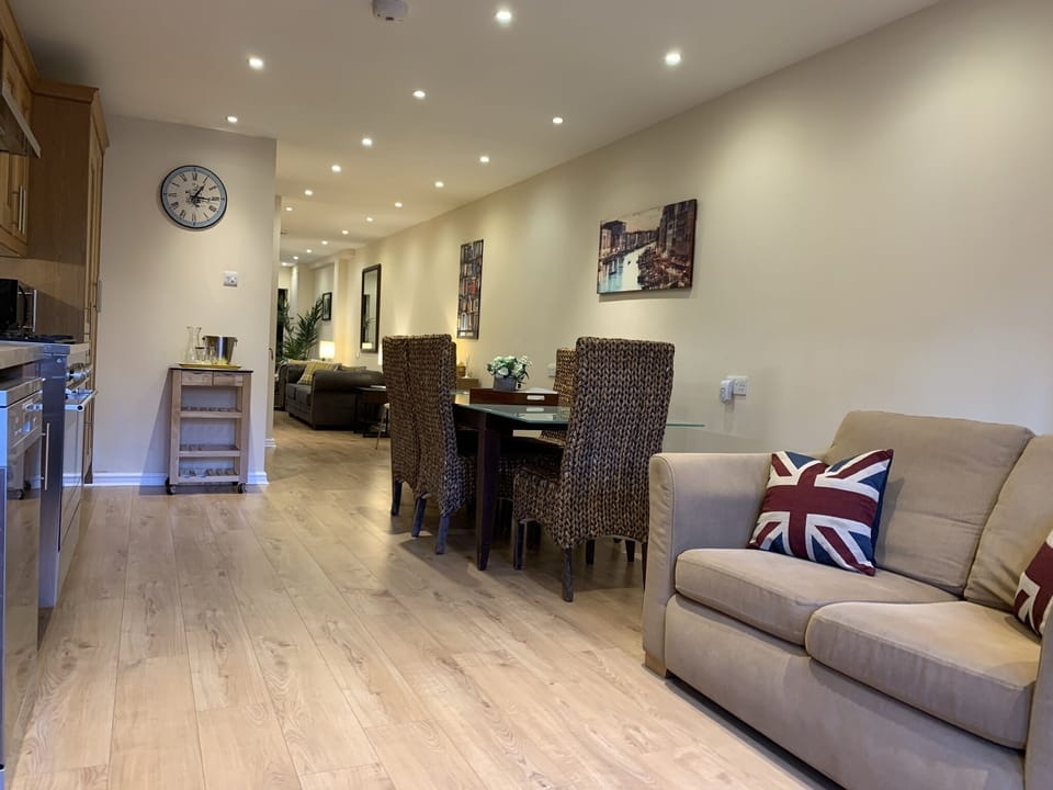 View from kitchen into lounge. Loveseat to keep the chef company!