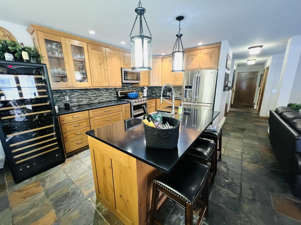 Beautifully appointed kitchen with stainless steel appliances & quartz counters