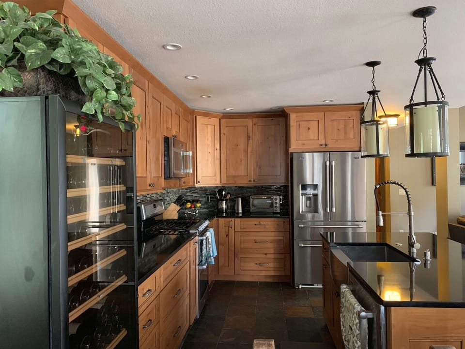 Beautifully appointed kitchen with stainless steel appliances & quartz counters
