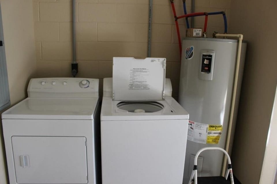 Laundry area with washer, dryer, and water heater