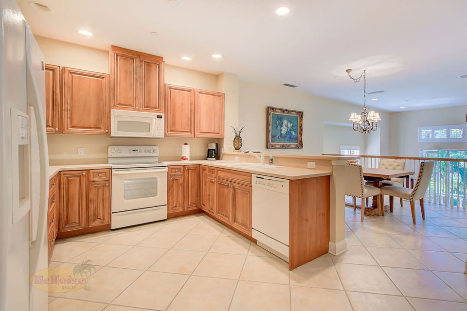 Gourmet Kitchen & Dining Area – Fully equipped with full-size appliances, granite countertops, and open-concept layout