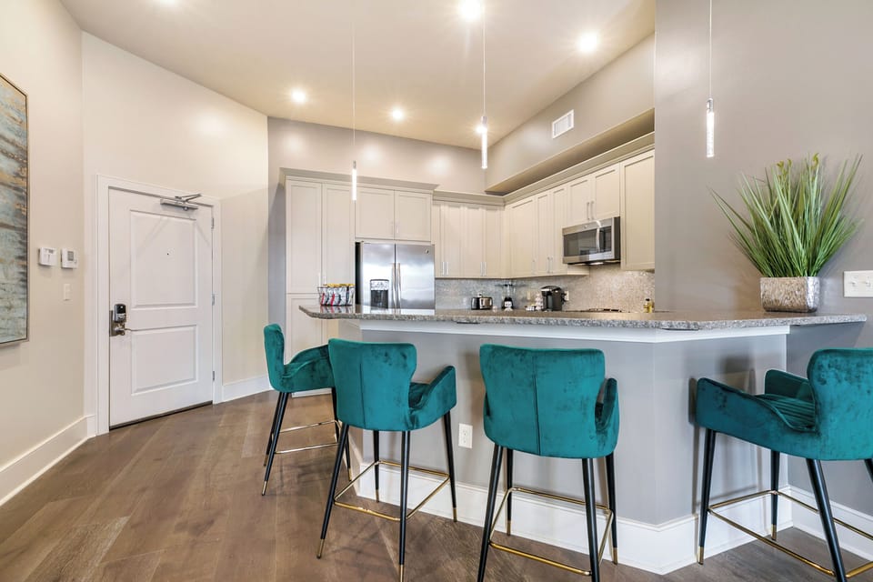 Cook and dine easily in the fully stocked kitchen, equipped with all stainless steel appliances, gas range, basic cookware, and a dining area for a comfortable meal at home. Entertain at the bar with seating for five.
