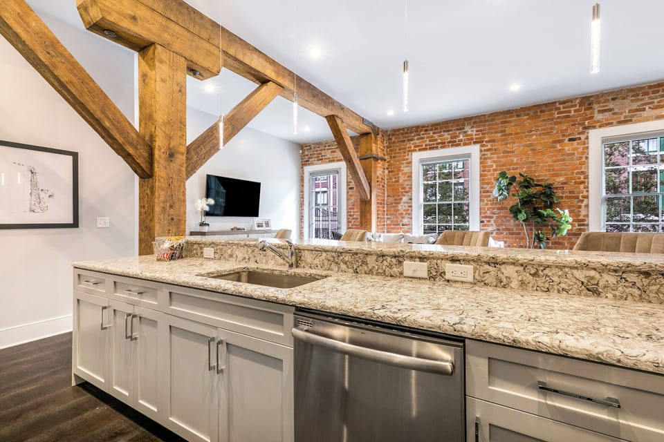 Cook and dine in the fully stocked kitchen with stainless steel appliances, gas range, basic cookware, and a dining area for a comfortable meal. Entertain at the bar with seating for four.
