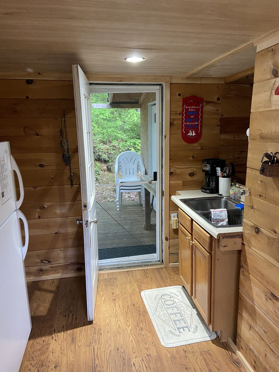 Back door in kitchen leading to back deck, 4 outside chairs