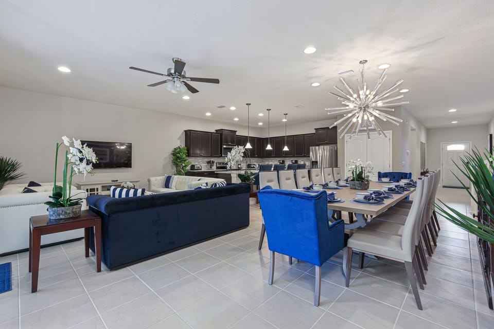 Spacious living room area adjacent to dining table, kitchen, and pantry