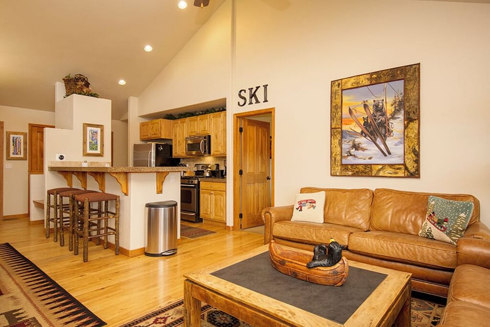 Your cozy mountain retreat with open living and full kitchen, perfect for après-ski relaxation and preparing hearty meals.