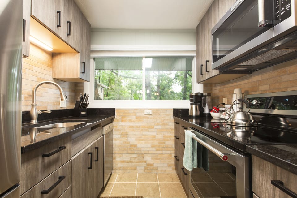 A snazzy galley kitchen with all modern appliances.