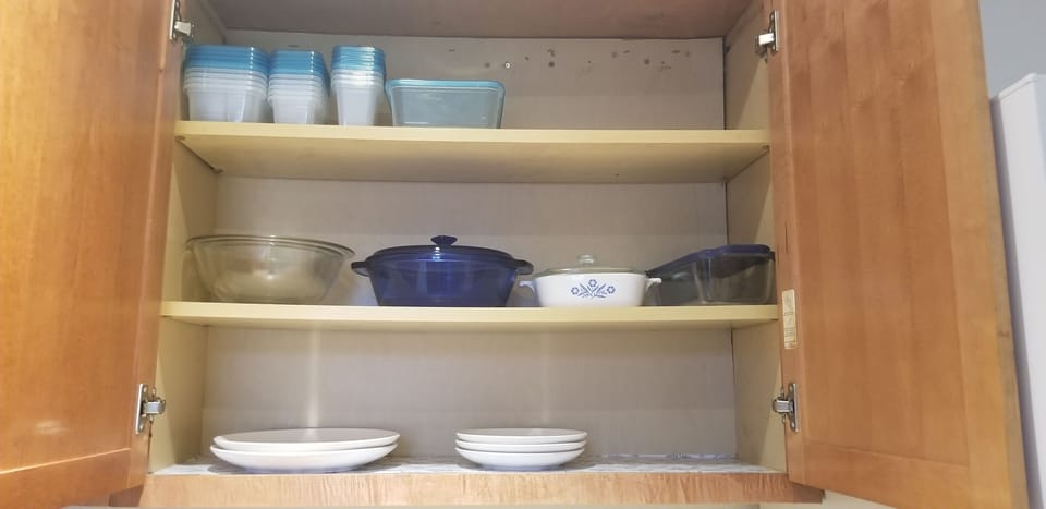 Some basic pots and pans and Tupperware for cooking 