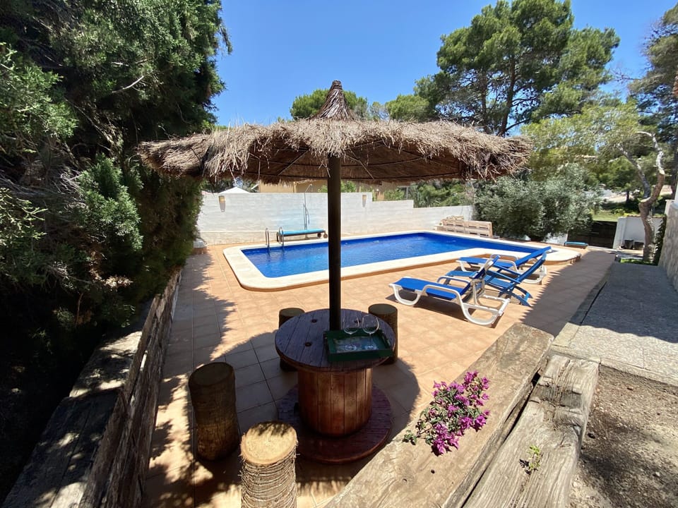 Pool area with 4 sunbeds & shaded seating area
