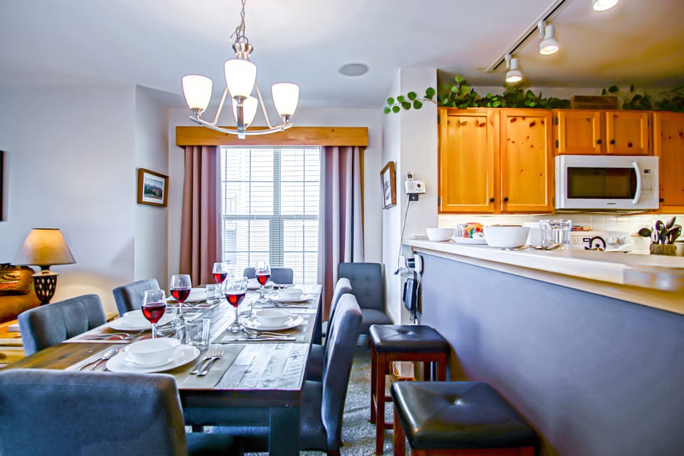 The dining room table has seating for 6 and the kitchen bar has seating for 2.