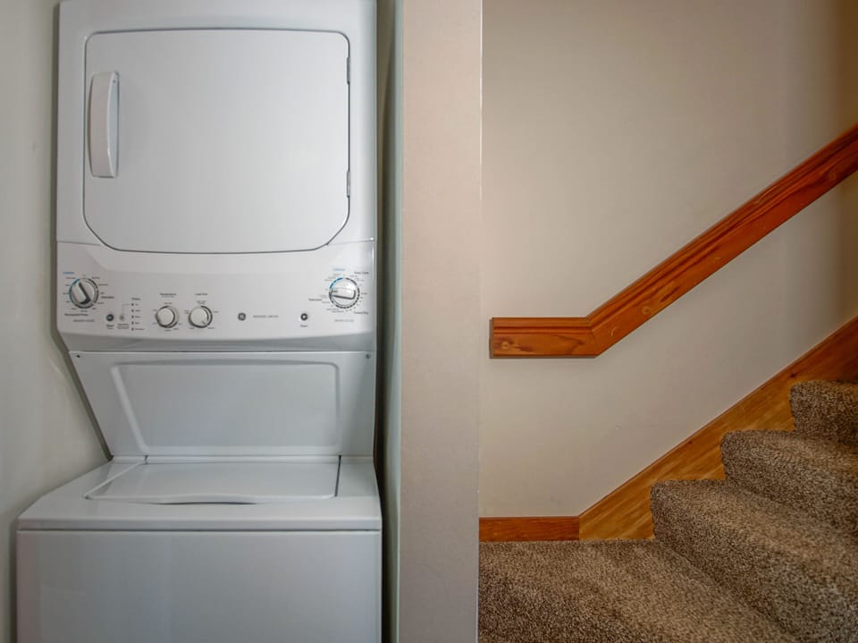 The washer and dryer are located to the left in the kitchen.