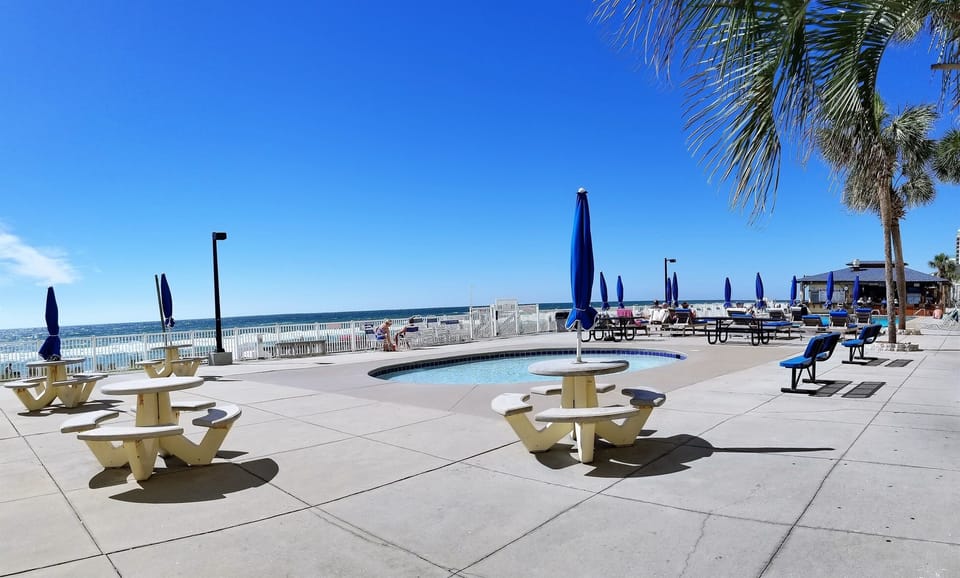 Steps to the kiddie pool, large pool, tiki hut and grills
