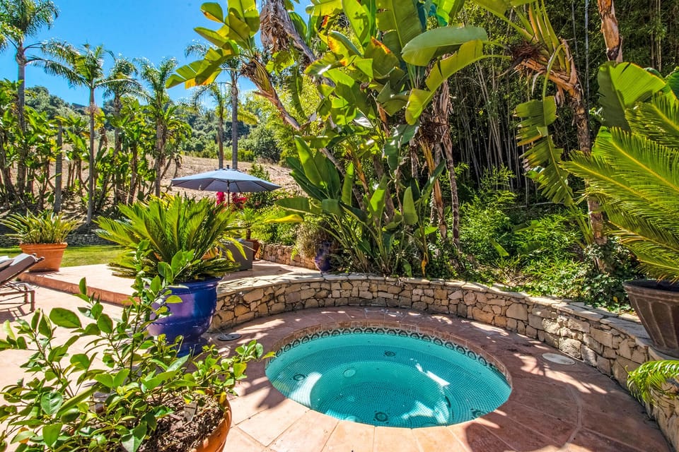 Naturistic Spa/Jacuzzi is nestled around beauty and flowers . Heaven on Earth.
