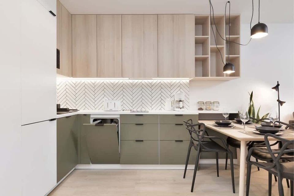 Kitchenette with plenty of kitchen utensils and dishes. 