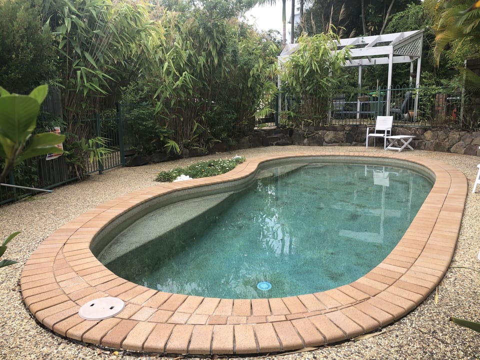 Private pool area with tropical plants 