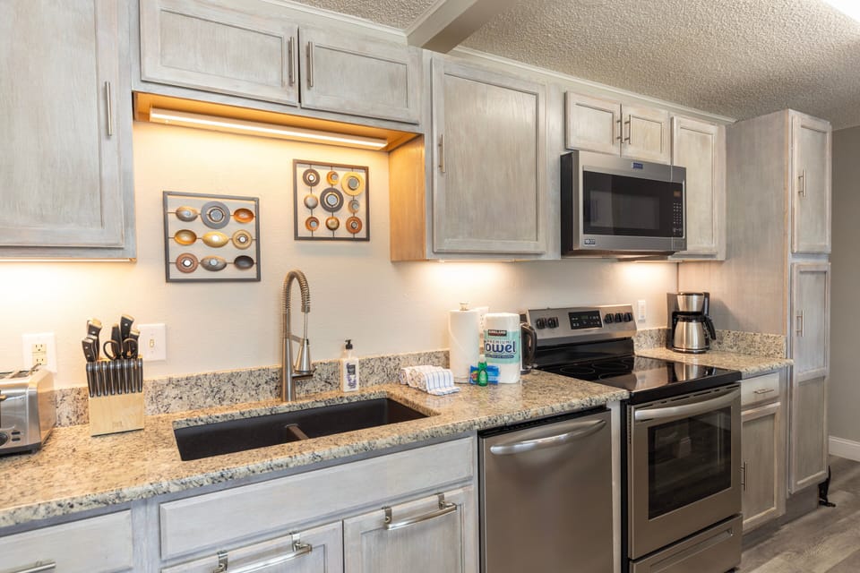 Full kitchen with stainless steel appliances.