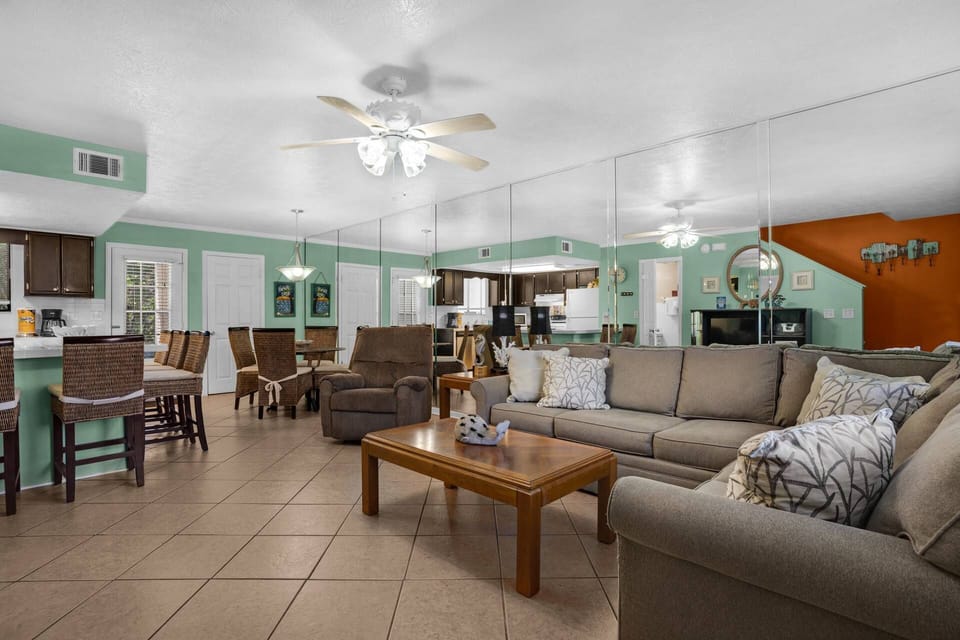 This unit showcases a bright, open-concept living space that seamlessly blends the kitchen, dining, and living room areas.
