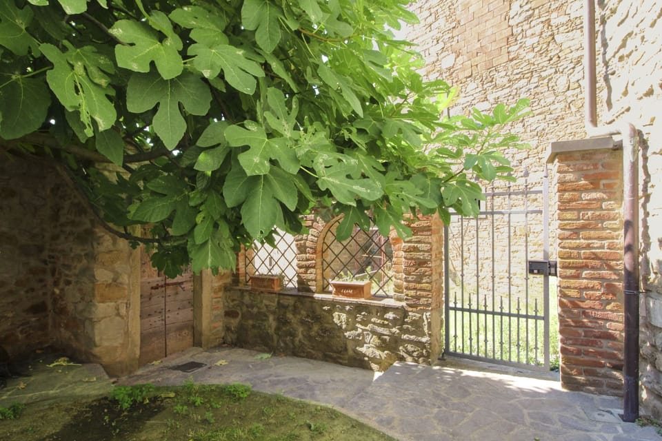 Ancient stone hamlet in an extremely panoramic position overlooking the wooded Val di Chio. Private Villa in Tuscany