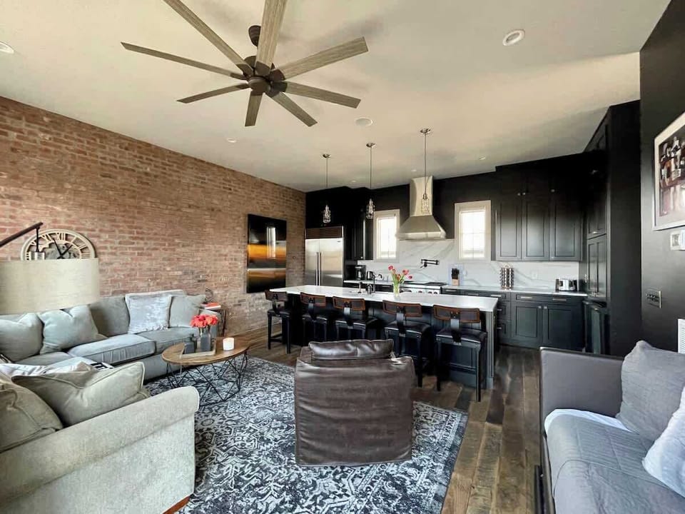 Unit A - LArge open living room with sectional sofas and a daybed for additional sleeping space