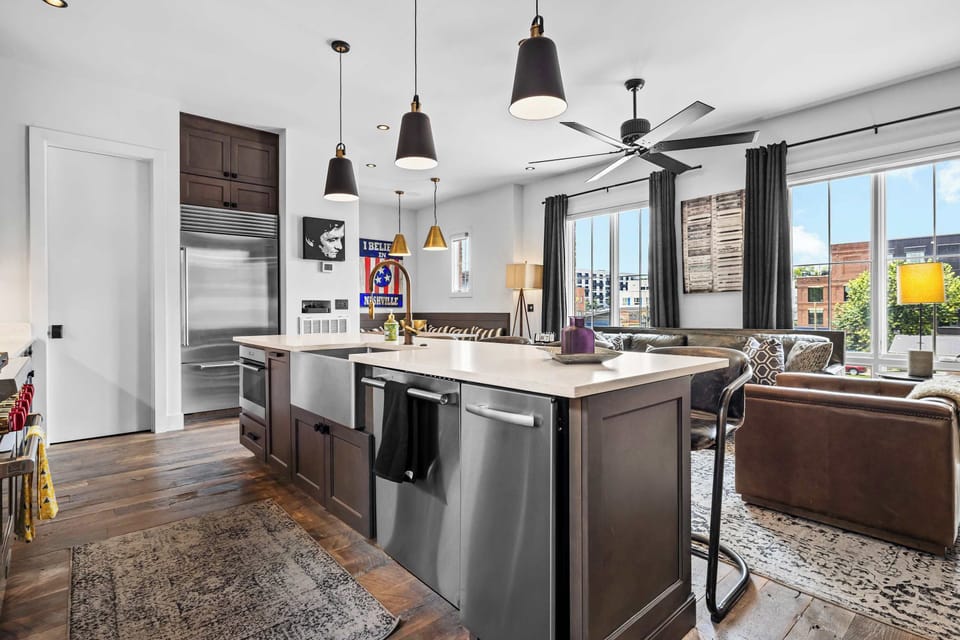 


Modern, fully equipped kitchen featuring stainless steel appliances, a large island with bar seating, ample counter space, and an open-concept layout perfect for cooking and gathering together.
