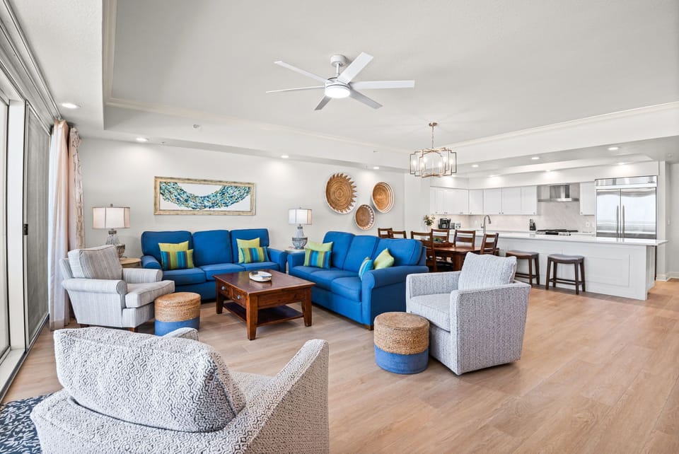 Settle into this open-concept living space, where thoughtful coastal decor and modern comforts blend seamlessly with the kitchen for easy vacation living.