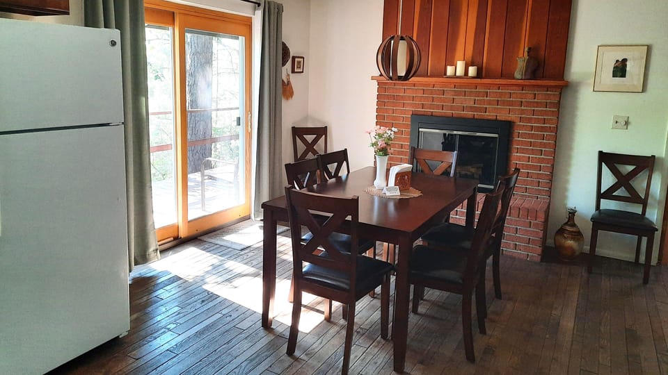 Spacious dining area with wood burning fireplace.