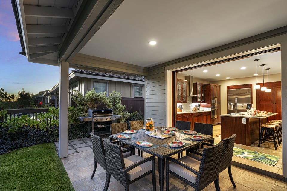 Outdoor dining table and chairs and private BBQ grill on the back lanai.