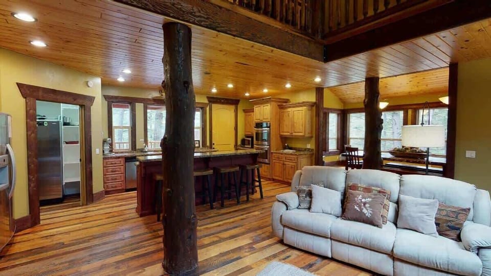 The open living room blends seamlessly into the cabin's cozy kitchen, creating a welcoming space perfect for gathering and unwinding.