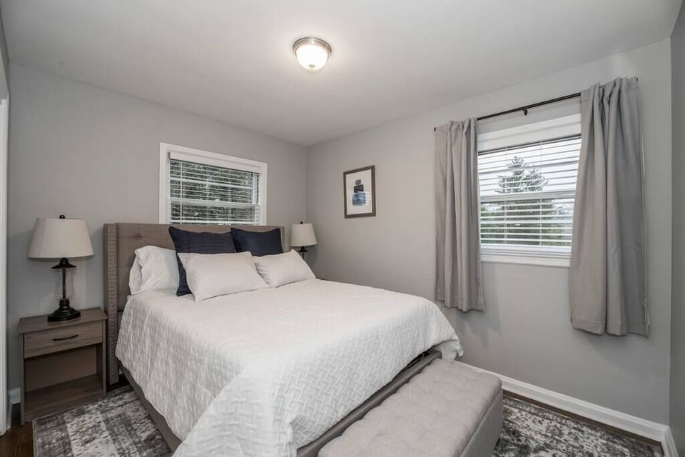 This first floor bedroom features a comfortable king bed and simple, welcoming décor, a relaxing space designed for rest and a pleasant stay.