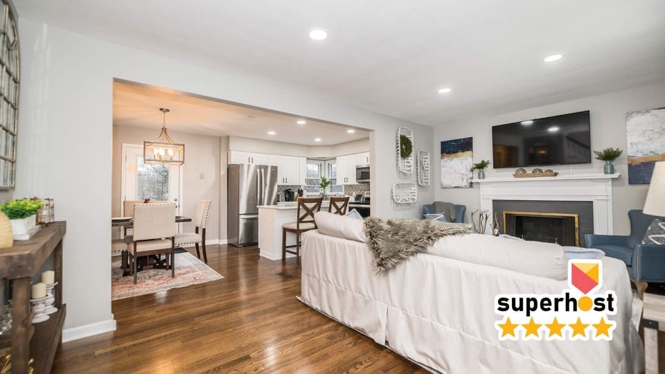 Inviting family room with a 65" TV, cozy fireplace, and bright white walls and fixtures. A stylish and comfortable space perfect for relaxing, watching movies, or spending time together.