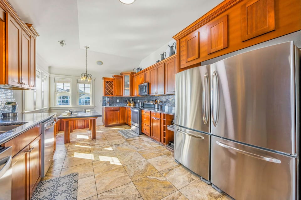 You'll love preparing meals in this spacious gourmet kitchen with rich wood cabinetry, granite counters, and stainless steel appliances.