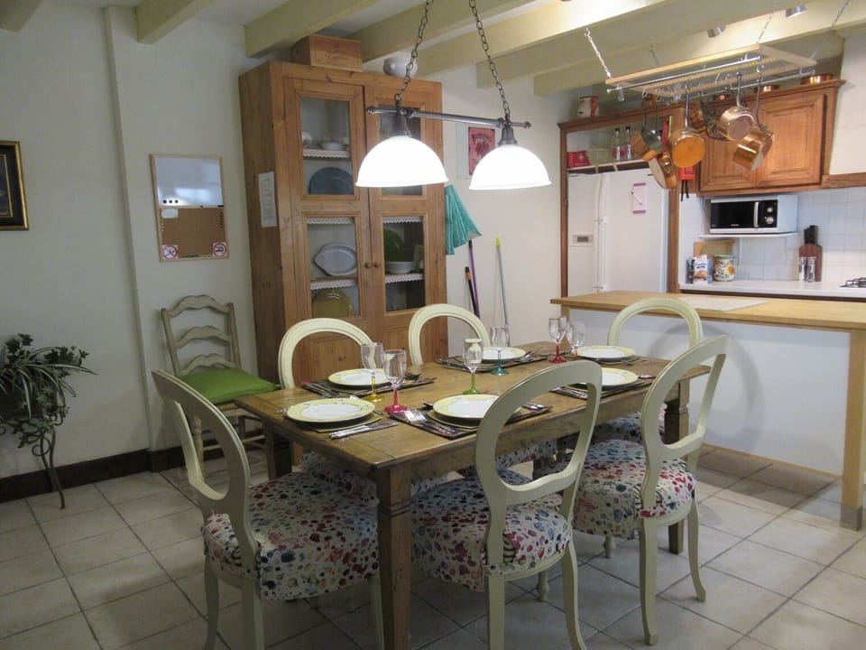 The large eat-in French country-style kitchen has seating for 6