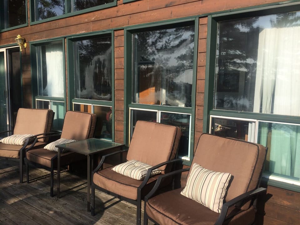 Wrap around deck with lots of seating. Also has a large patio table where you can enjoy meals outside.