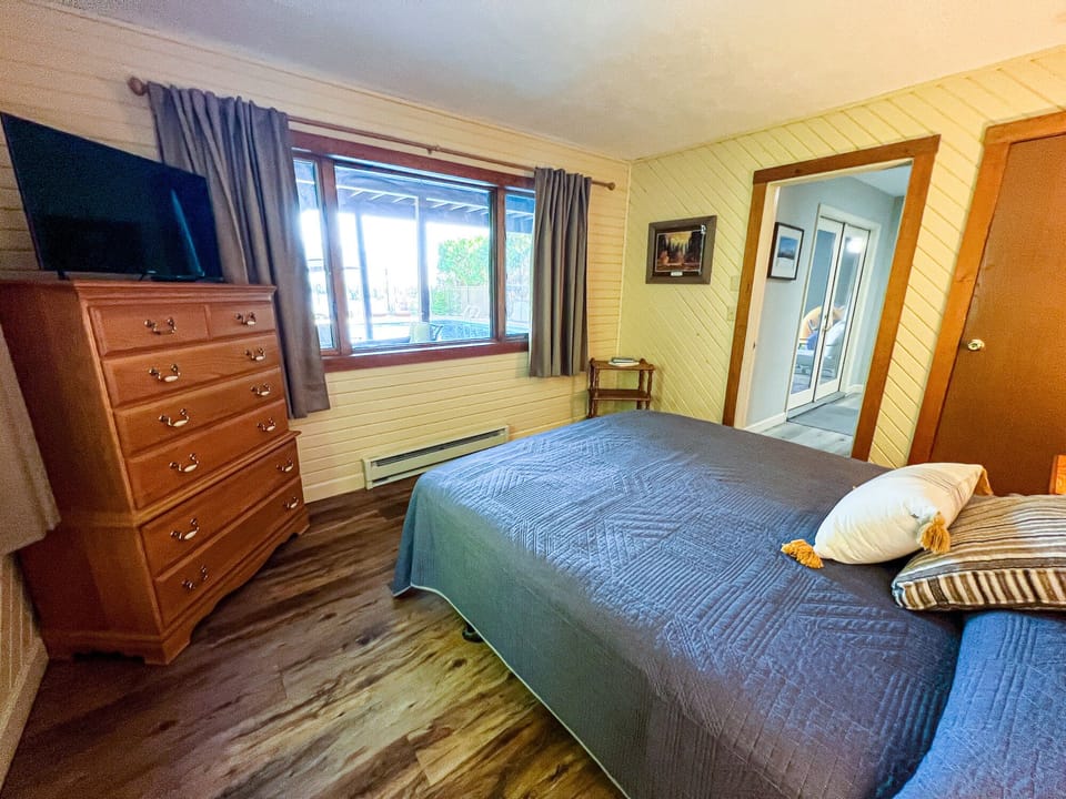 1st Floor Queen Bedroom w/ Lake View; the pool is through the patio doors.
