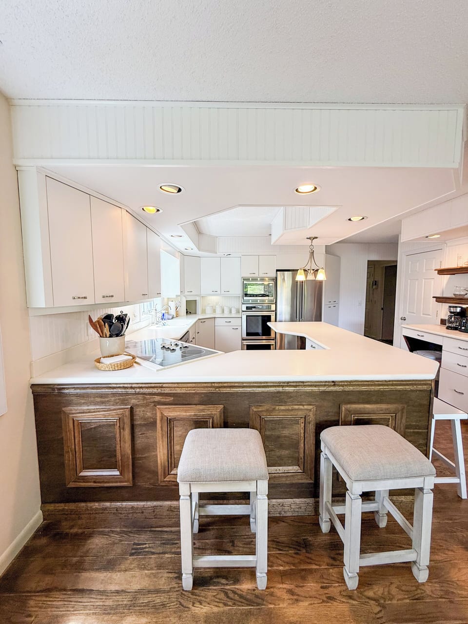 Kitchen on the 2nd Floor, with two ovens, a gas stove, and a bar with stools.