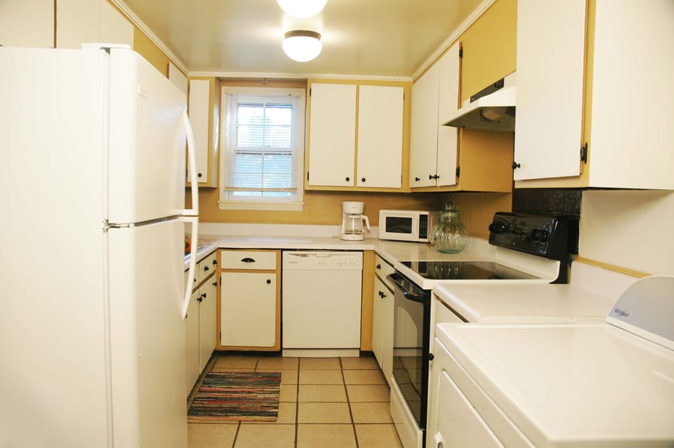 Kitchen includes coffee maker, microwave, oven, refrigerator, dishwasher.