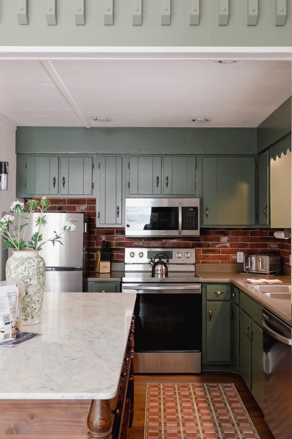 A newly renovated kitchen including stainless steel appliances, dishwasher and large center island from Anthropologie.