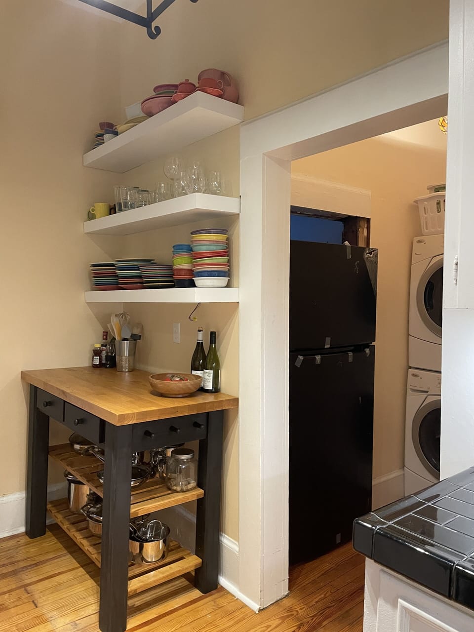 Featuring open shelving, and a full compliment of dishes and cookware