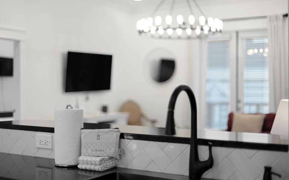 Enjoy your morning coffee in this bright, modern kitchen with sleek fixtures and stylish tile backsplash.