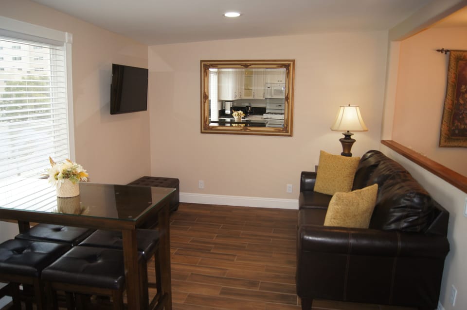Living Area with Queen Size Couch and 40" 4K LED Smart TV.