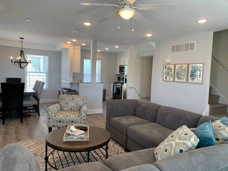 Bright, open floor plan with living, dining and kitchen areas. .