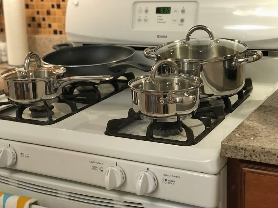 Our kitchen is fully stocked with cookware, plates, and utensils.