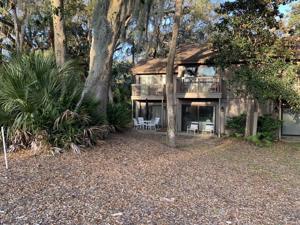Rear elevation. Patio behind family area. Two balconies one off of each bedroom
