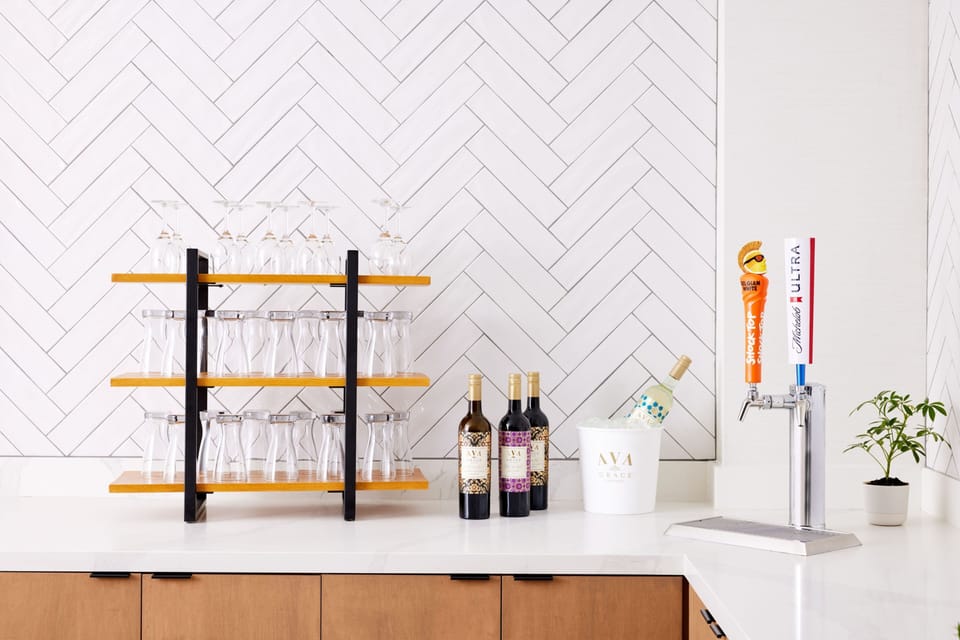 Bar counter featuring glassware and bottles of wine.